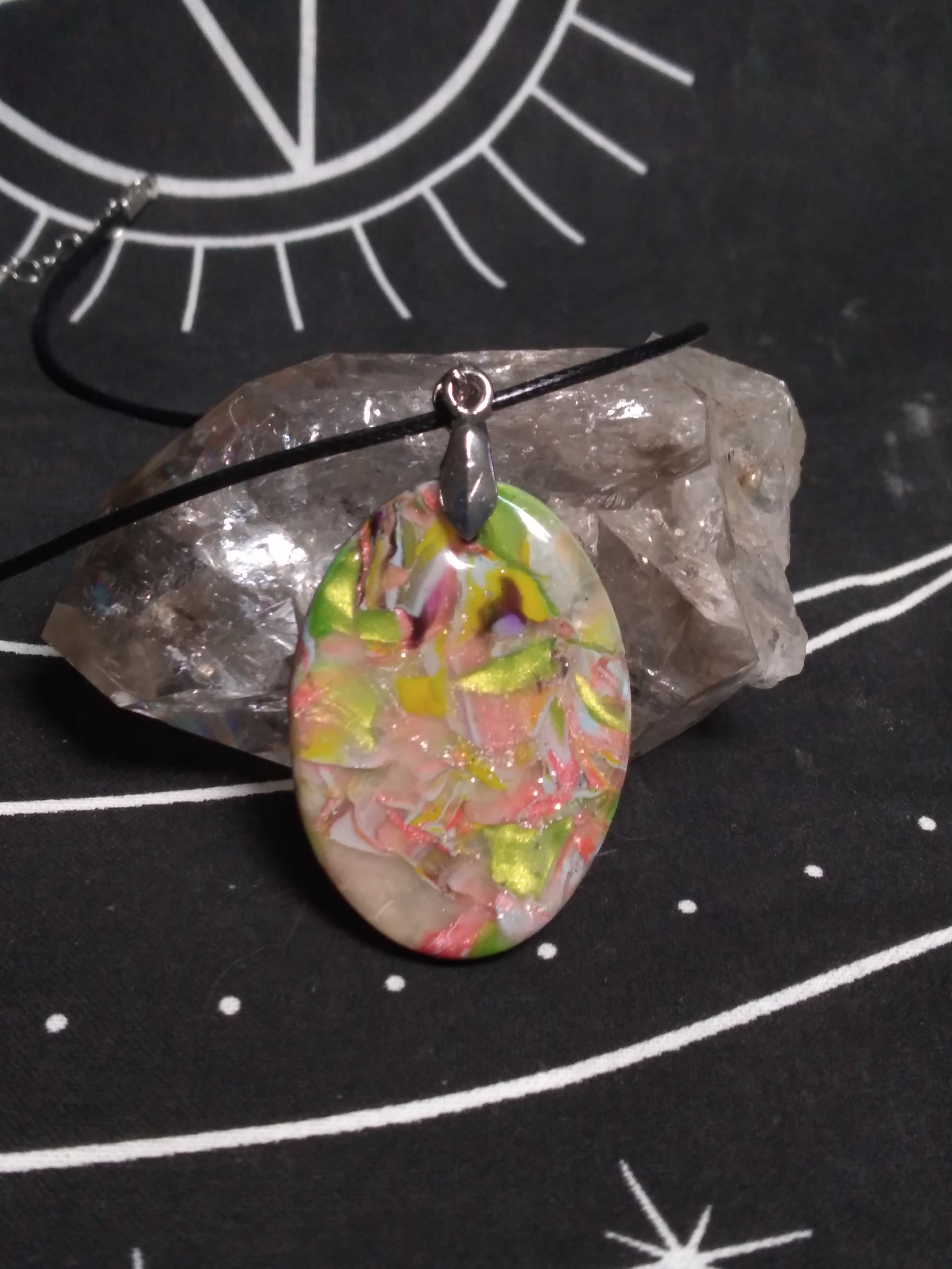Multicolored pendant on black cord