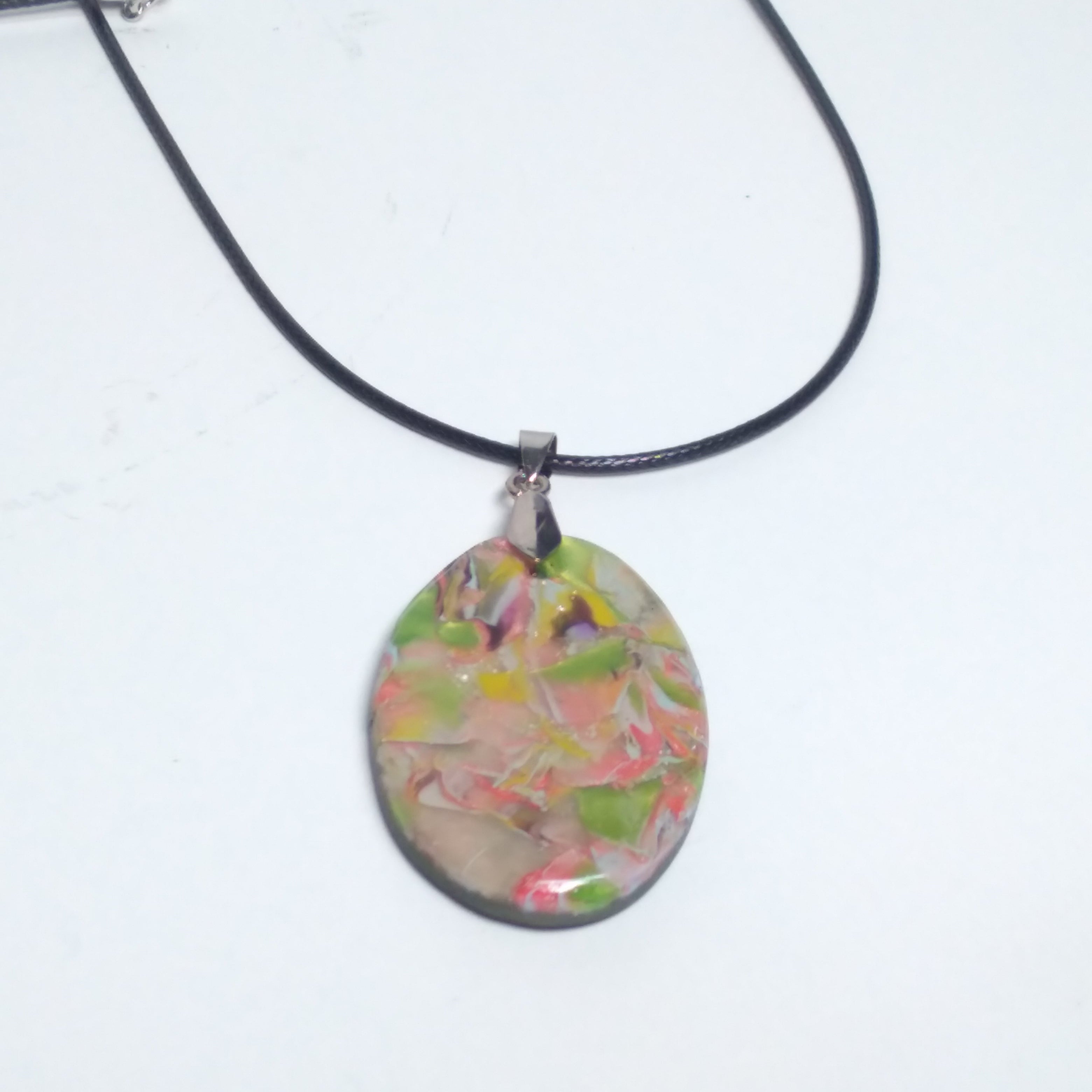 Multicolored pendant on black cord