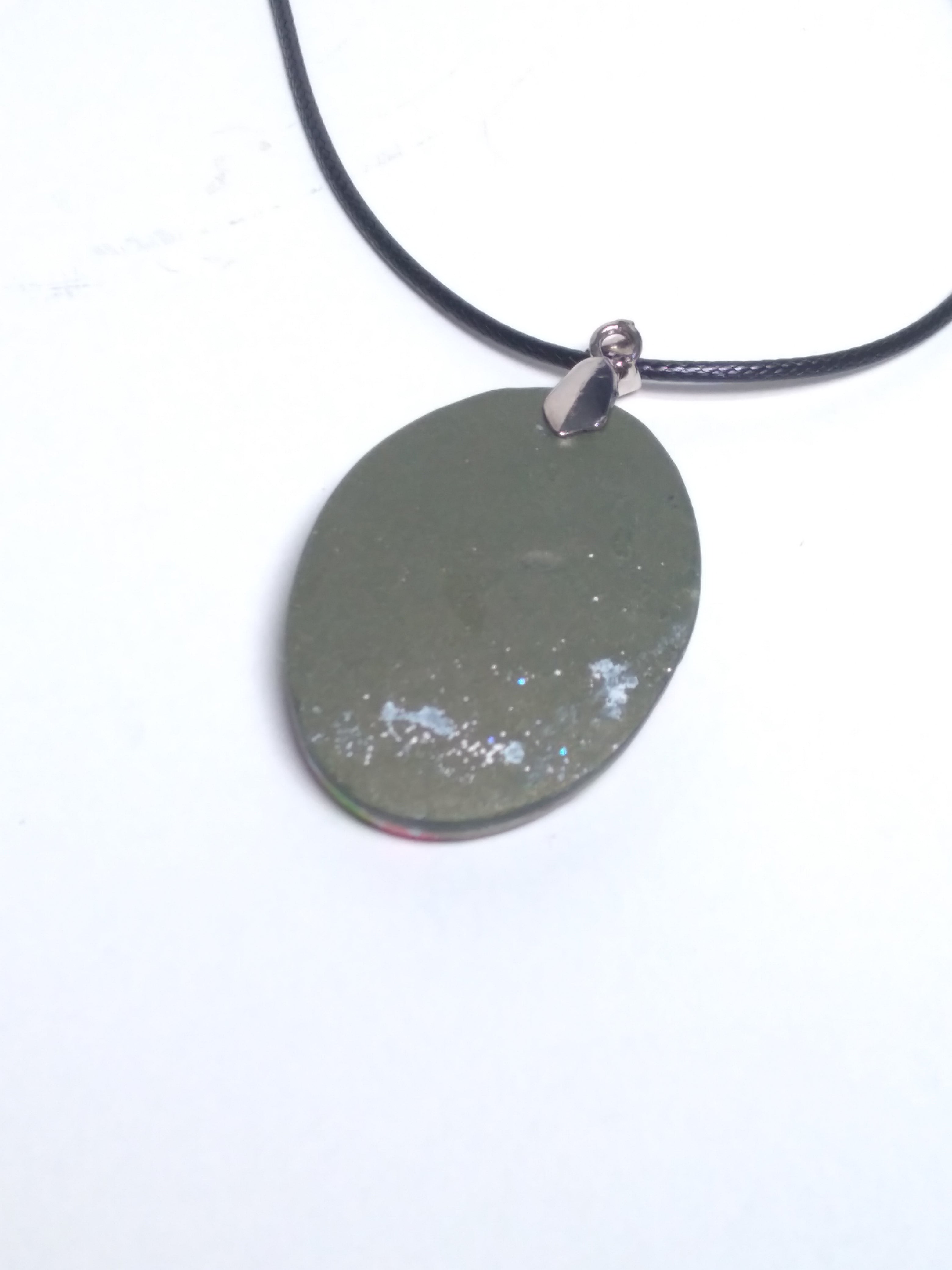 Multicolored pendant on black cord
