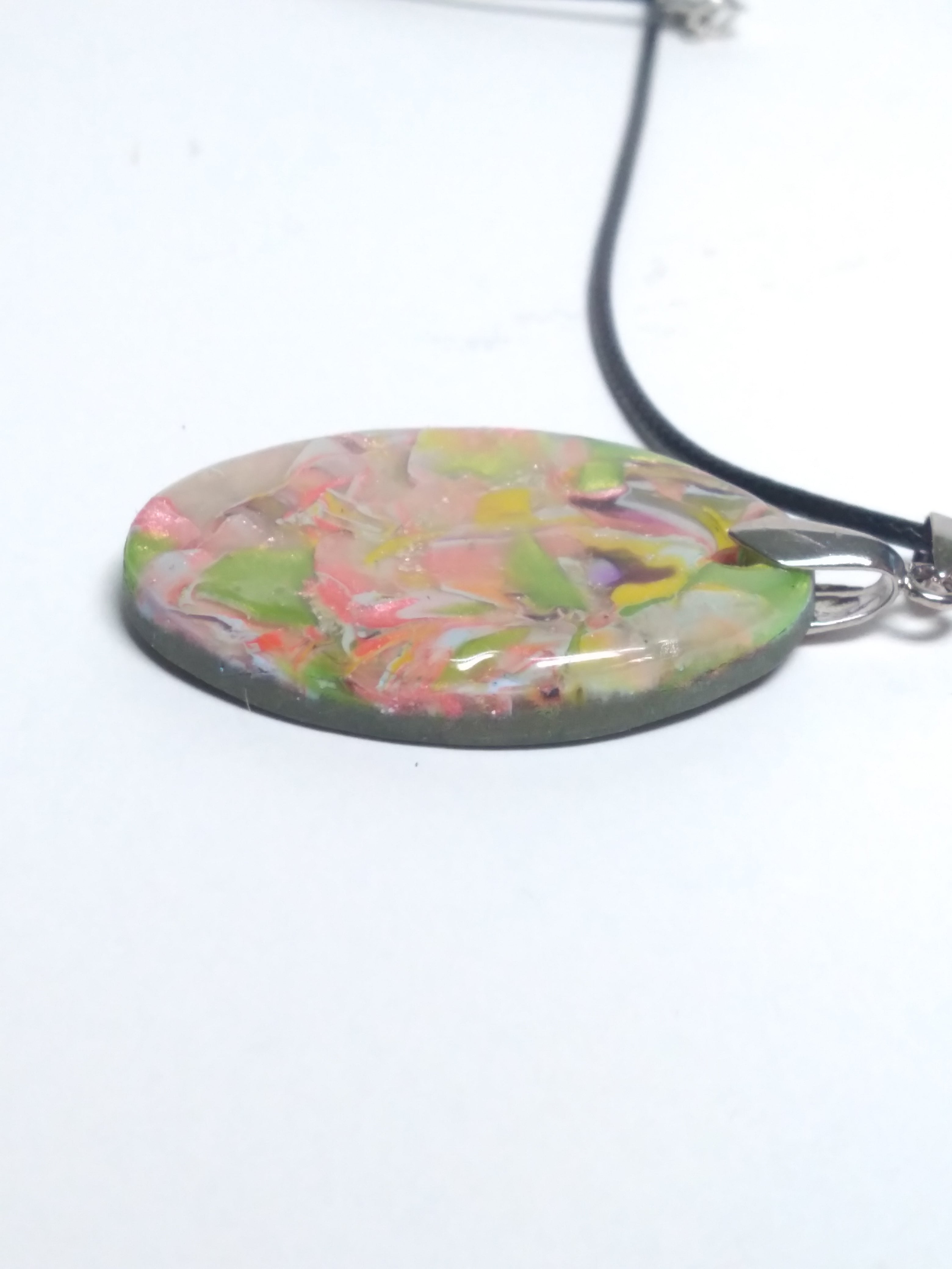 Multicolored pendant on black cord