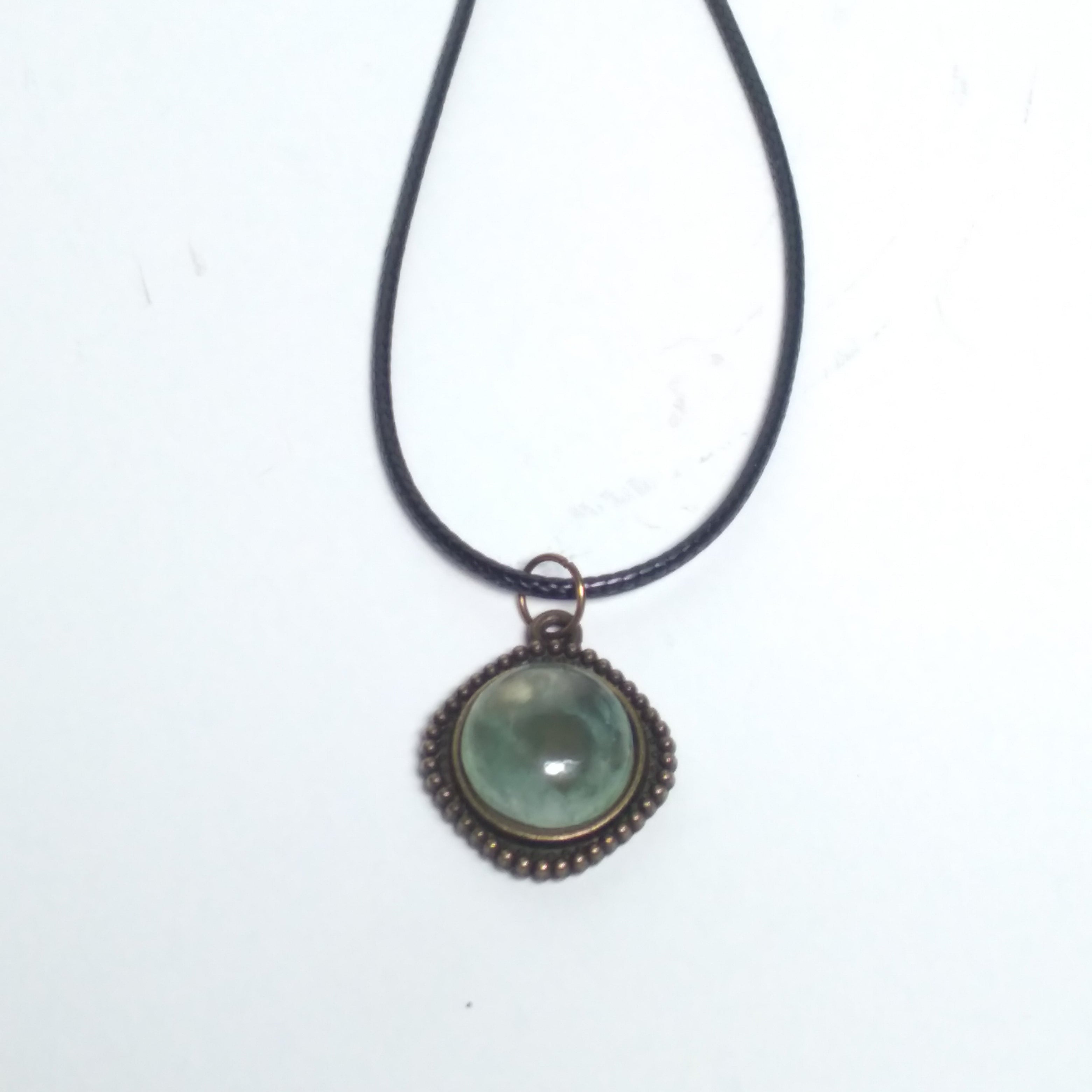 Round prehnite pendant on black cord