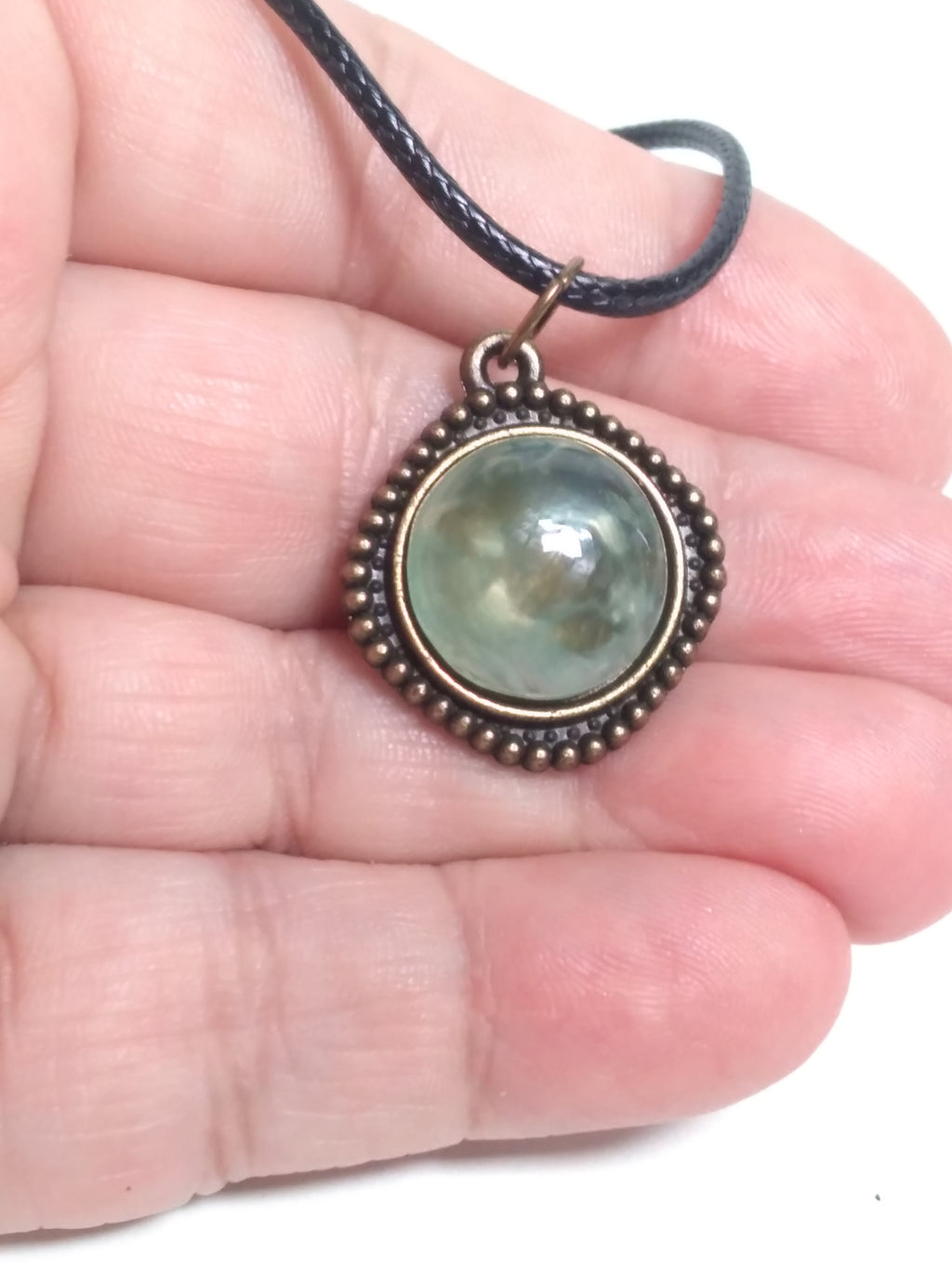 Round prehnite pendant on black cord