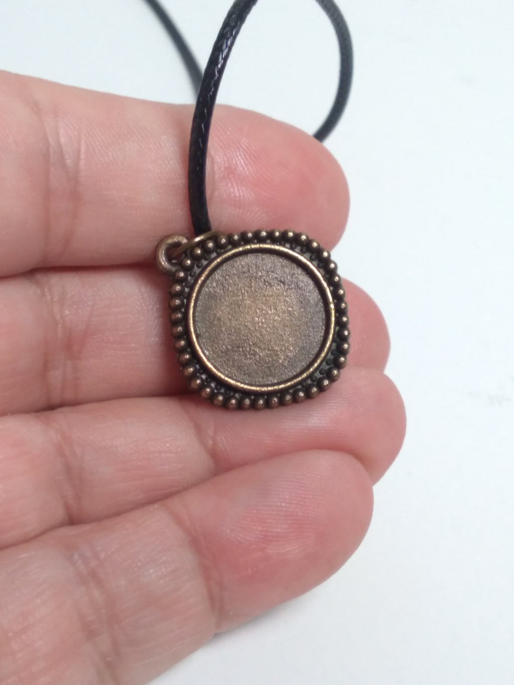 Round prehnite pendant on black cord
