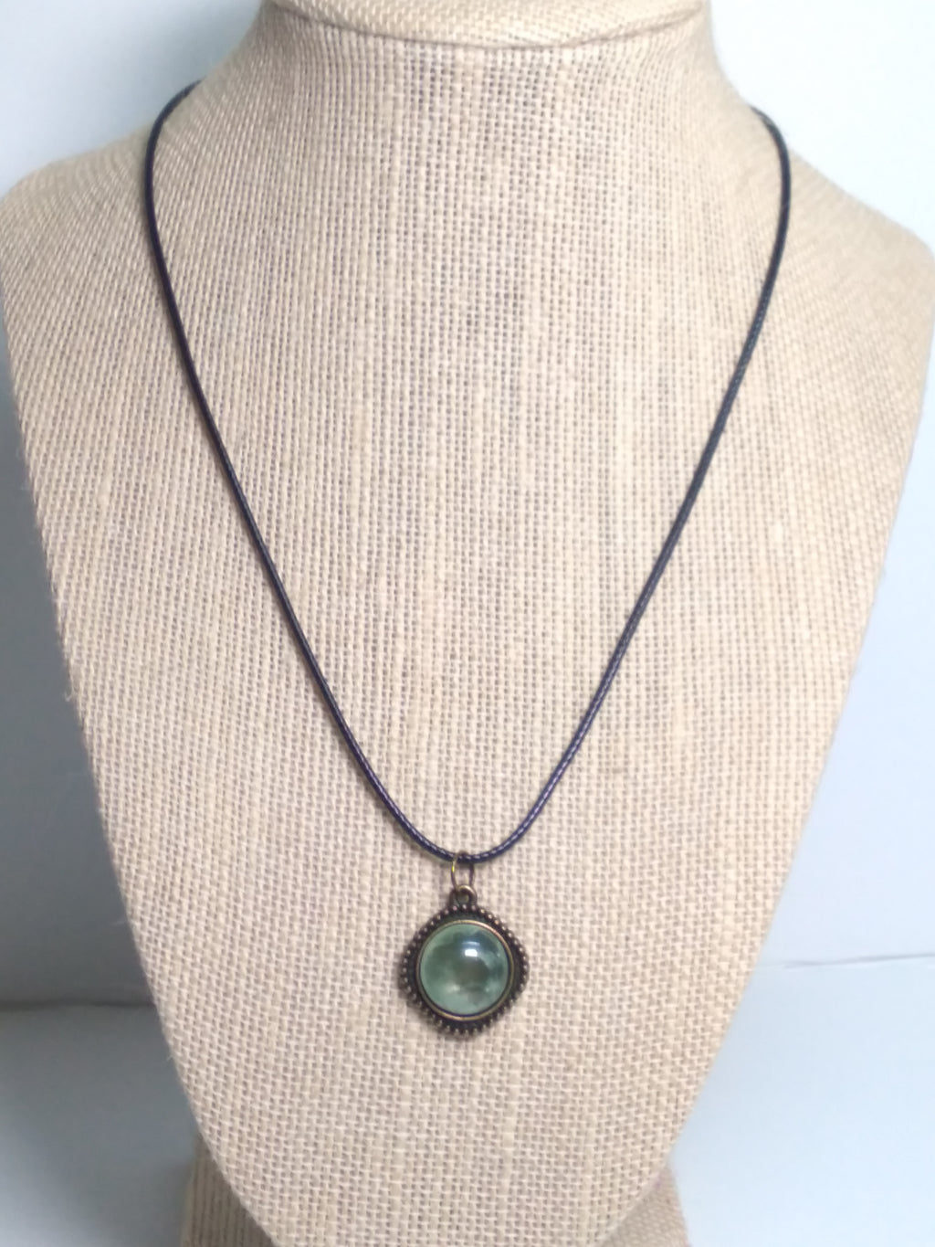 Round prehnite pendant on black cord