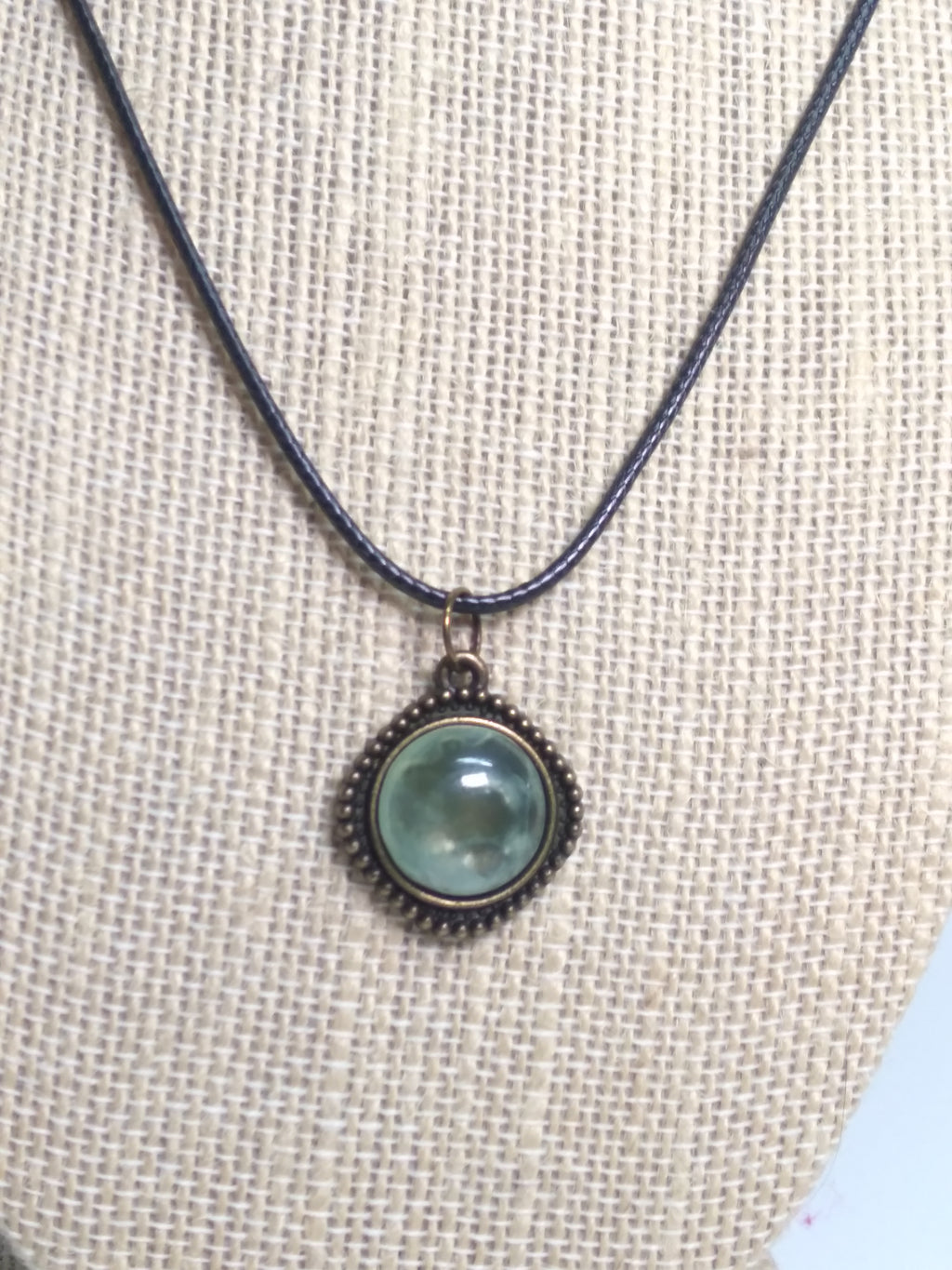 Round prehnite pendant on black cord